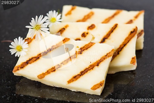 Image of Halloumi cheese frying in grill pan.