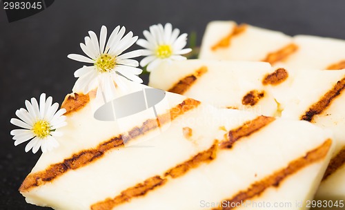 Image of Halloumi cheese frying in grill pan.