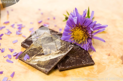 Image of dark chocolate on a wooden table.