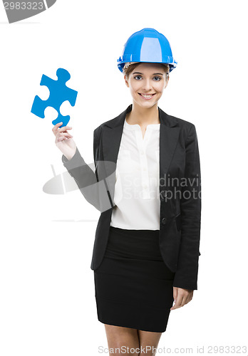 Image of Female engineer with a puzzle piece