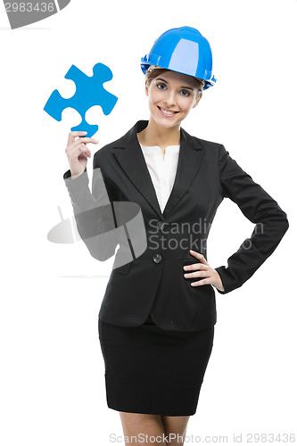 Image of Female engineer with a puzzle piece