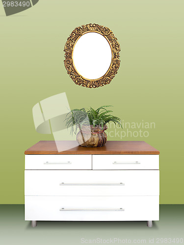 Image of Modern chest of drawers and gilded Frame on wall