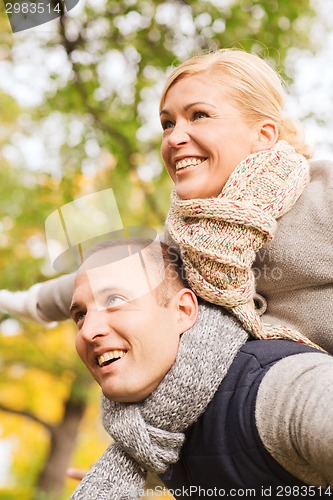 Image of smiling couple having fun in autumn park
