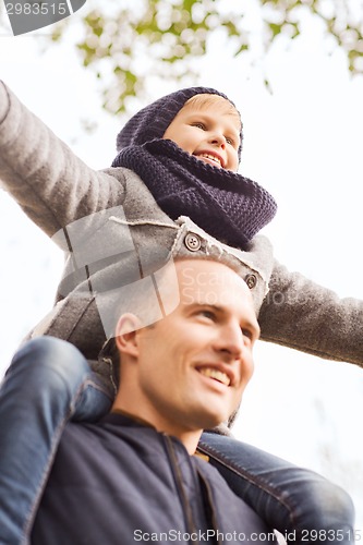 Image of happy family having fun in autumn park