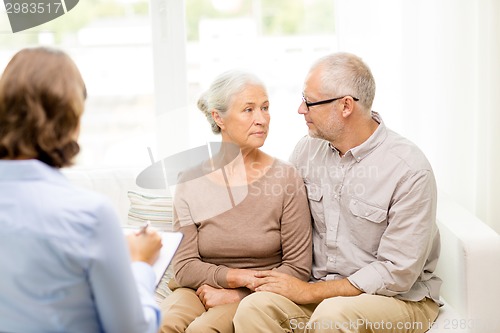 Image of senior couple hugging at home