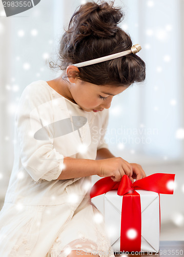 Image of smiling little girl with gift box