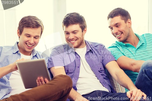 Image of smiling friends with tablet pc computers at home