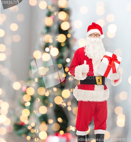 Image of man in costume of santa claus with gift box