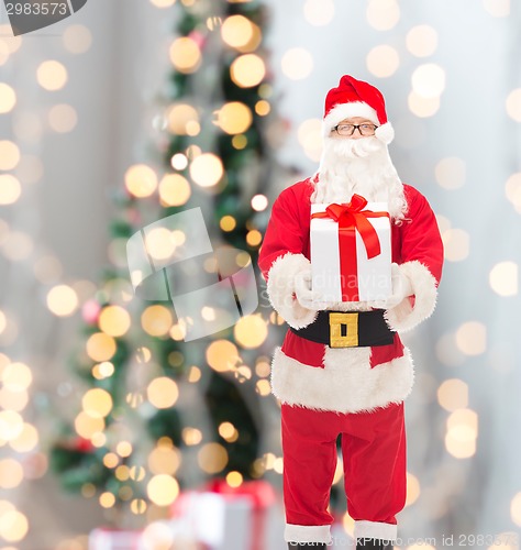 Image of man in costume of santa claus with gift box