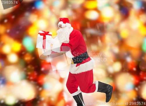 Image of man in costume of santa claus with gift box