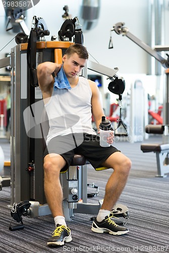 Image of man exercising on gym machine