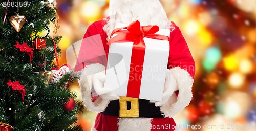 Image of man in costume of santa claus with gift box