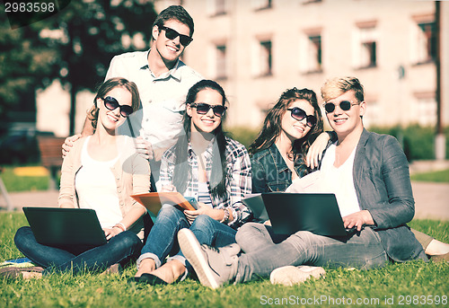 Image of students or teenagers with laptop computers