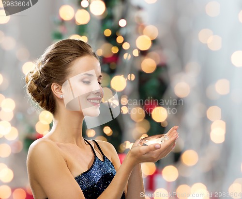 Image of smiling woman in evening dress with diamond