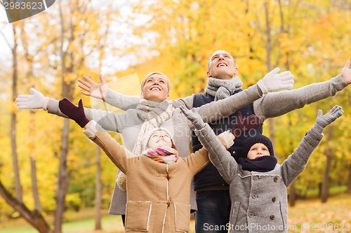 Image of happy family having fun in autumn park