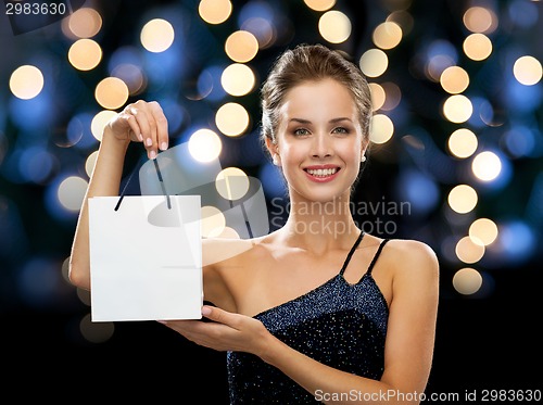 Image of smiling woman with white blank shopping bag