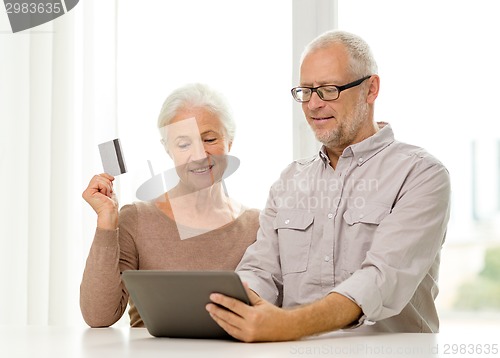 Image of happy senior couple with tablet pc and credit card