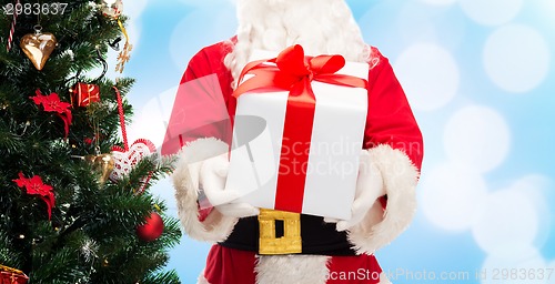 Image of man in costume of santa claus with gift box