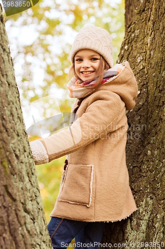 Image of smiling little girl autumn in park