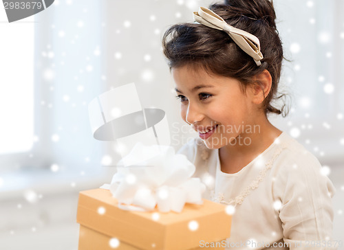 Image of smiling little girl with gift box