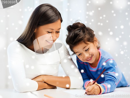 Image of mother and daughter with coloring pencils indoors