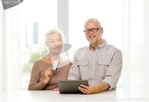 Image of happy senior couple with tablet pc and credit card