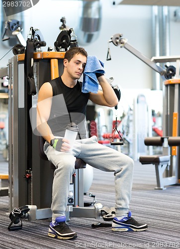 Image of man exercising on gym machine