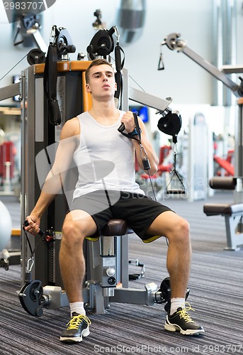Image of man exercising on gym machine