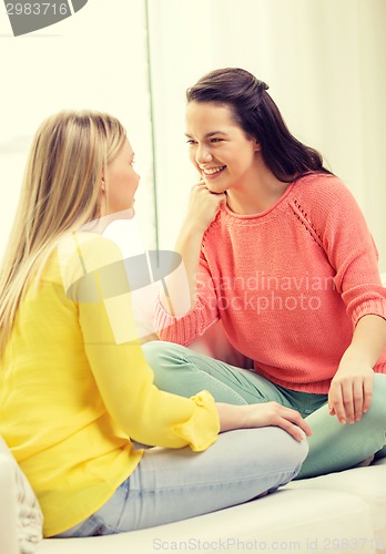 Image of two girlfriends having a talk at home