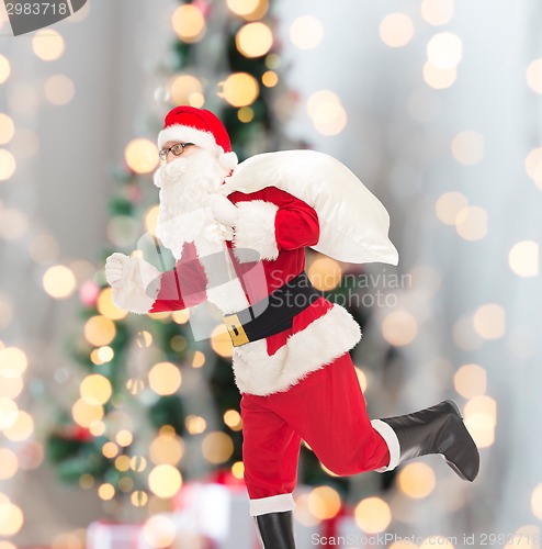 Image of man in costume of santa claus with bag