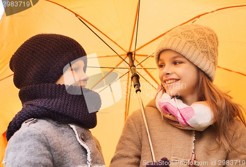 Image of close up of smiling children in autumn park