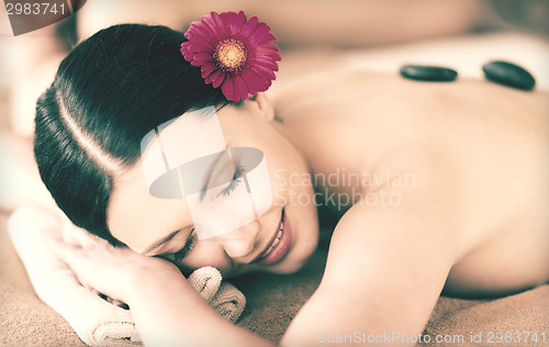 Image of woman in spa with hot stones