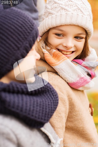 Image of close up of smiling children in autumn park