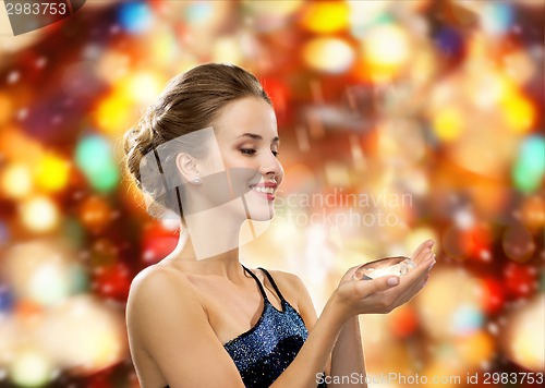 Image of smiling woman in evening dress with diamond