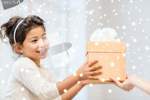 Image of smiling little girl with gift box