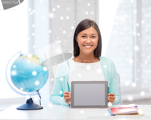 Image of smiling young woman with globe and tablet pc