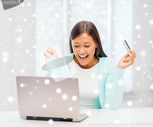 Image of businesswoman with laptop and credit card