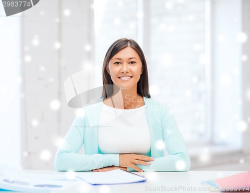 Image of smiling young woman with globe and tablet pc