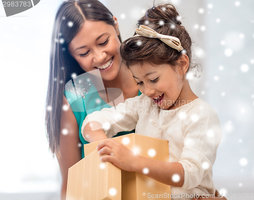 Image of happy mother and child girl with gift box