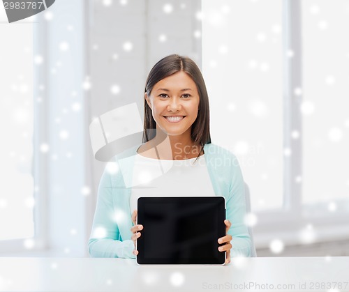 Image of smiling young woman with globe and tablet pc