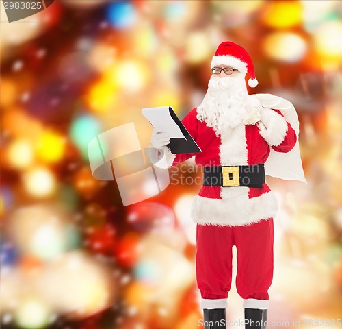 Image of man in costume of santa claus with notepad and bag