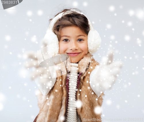 Image of happy littl girl in winter clothes