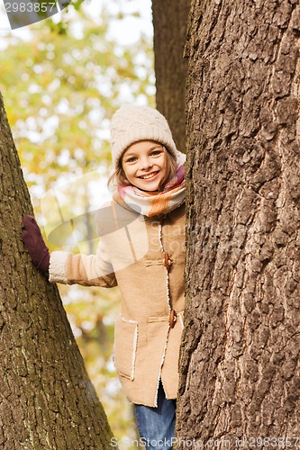 Image of smiling little girl autumn in park