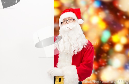 Image of man in costume of santa claus with billboard