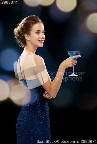 Image of smiling woman holding cocktail