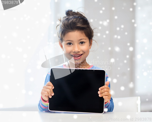 Image of smiling girl with tablet pc at home