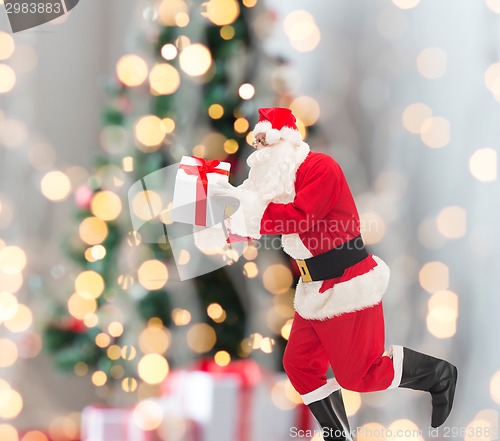 Image of man in costume of santa claus with gift box