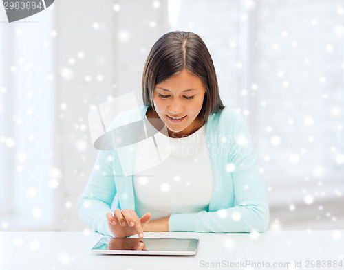 Image of smiling young woman with globe and tablet pc