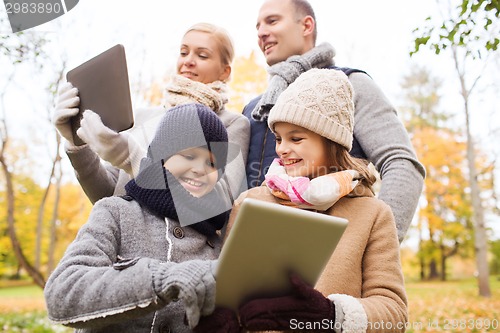 Image of happy family with tablet pc in autumn park