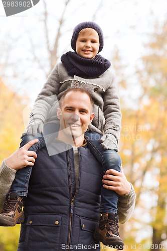 Image of happy family having fun in autumn park